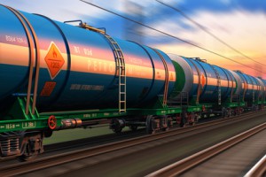 Cargo railway shipping industry and freight railroad transportation industrial concept: modern high speed train with petroleum tankcars on tracks with motion blur effect