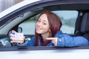 Attractive caucasian girl showing her driver license