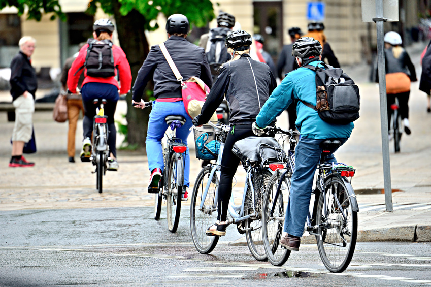 Bicyclists on their way home in the rain, properly dressed with helmets and gear